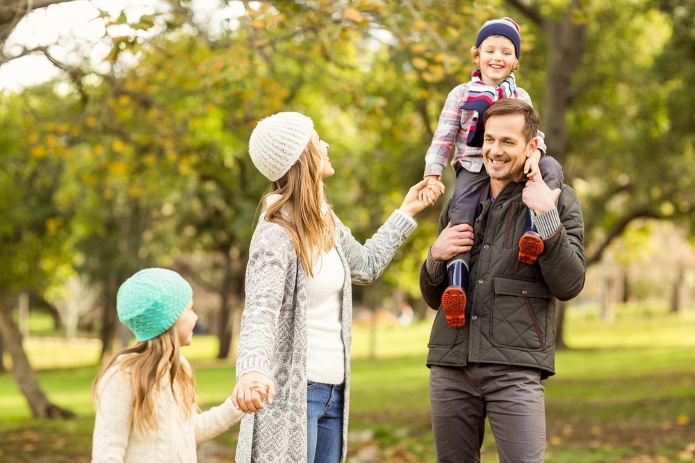 Portrait of a smiling young family on an autumns day secure your rental before you even land in Australia